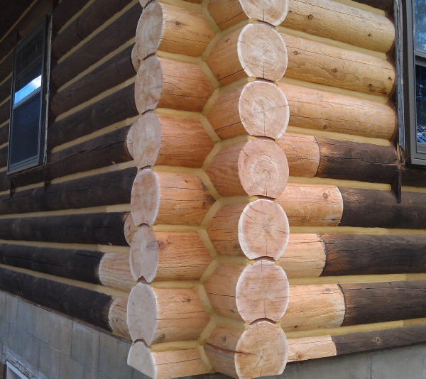 A corner of a log home that has been replaced with new cedar logs.
