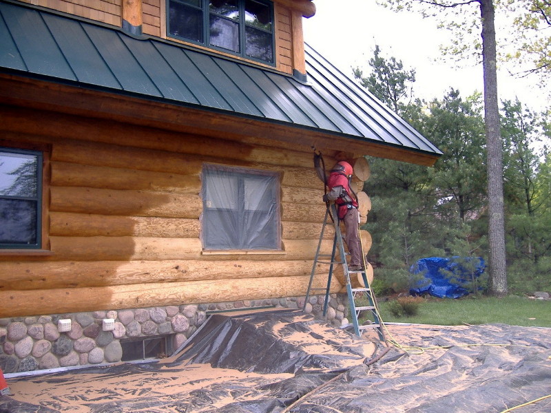 Finish being sandblasted off of a wood home.