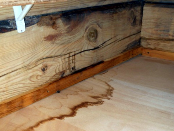 a stain left on a floor by a water leak in a log home.