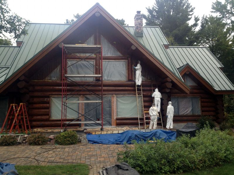 Crew prepping for staining log home
